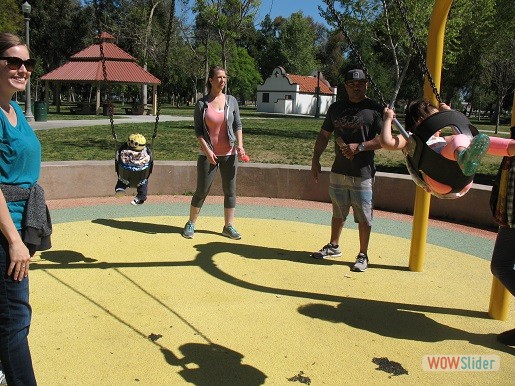 parents are playing with their children at park day